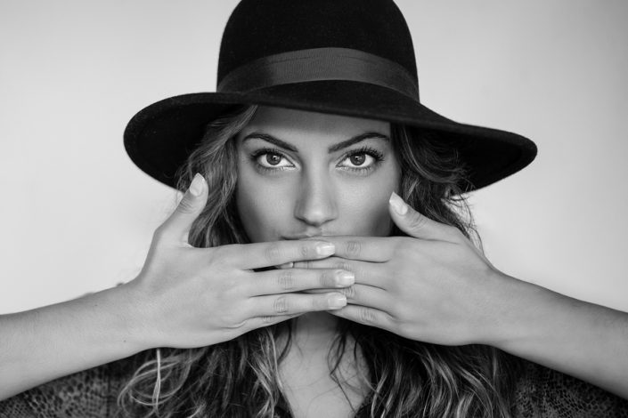 female hands to mouth, black hat for professional portraits Toronto 1721-4