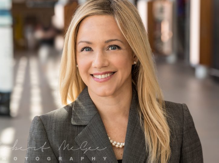 Smiling executive in grey jacket, professional headshots Toronto location