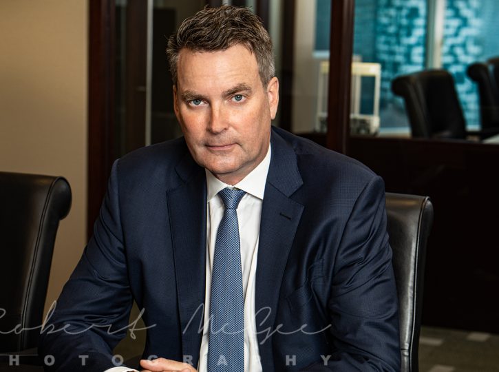 Warren from Rosseau Asset Managment seated behind desk for professional headshot 019A2100