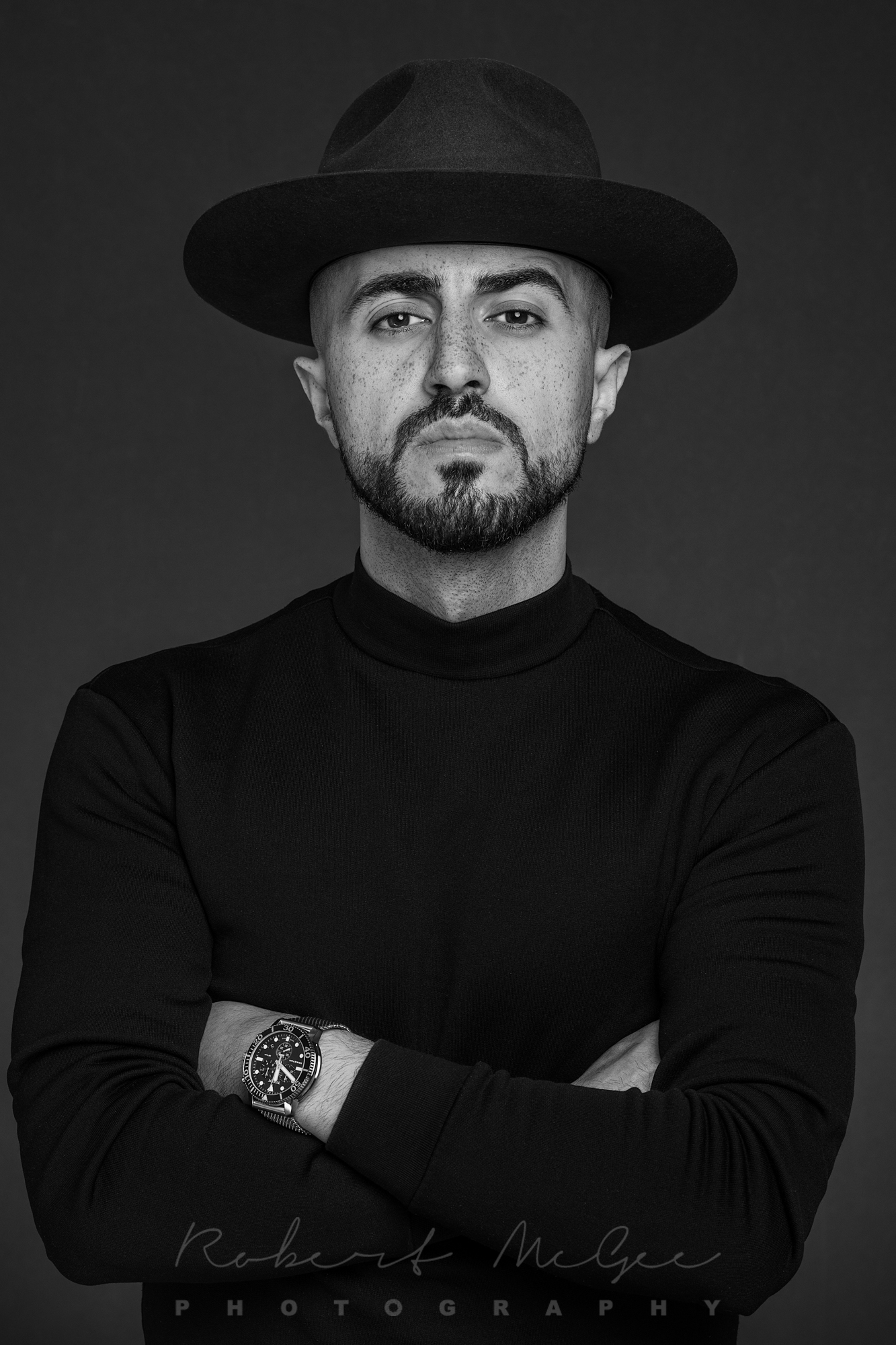 black and white portrait of Nabel arms crossed wearing hat 019A5003