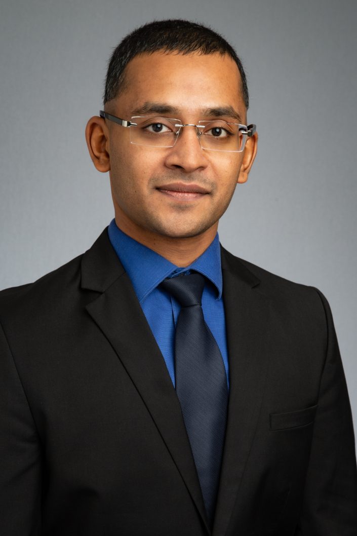 company wide, consistent look headshot for business website, vertical with grey backdrop 0O7C5806