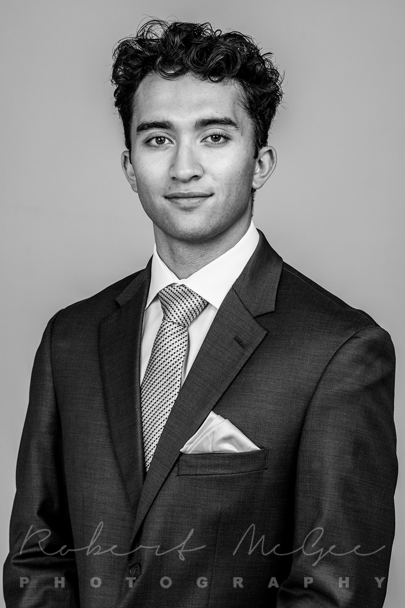 portrait of young actor in suit gazing directly at camera, black and white image 019A2706