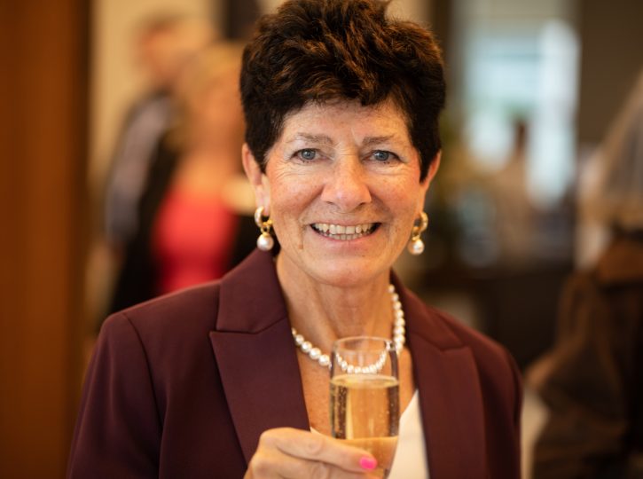 guest at corporate event toasts the evening with a glass of champagne 090A3792