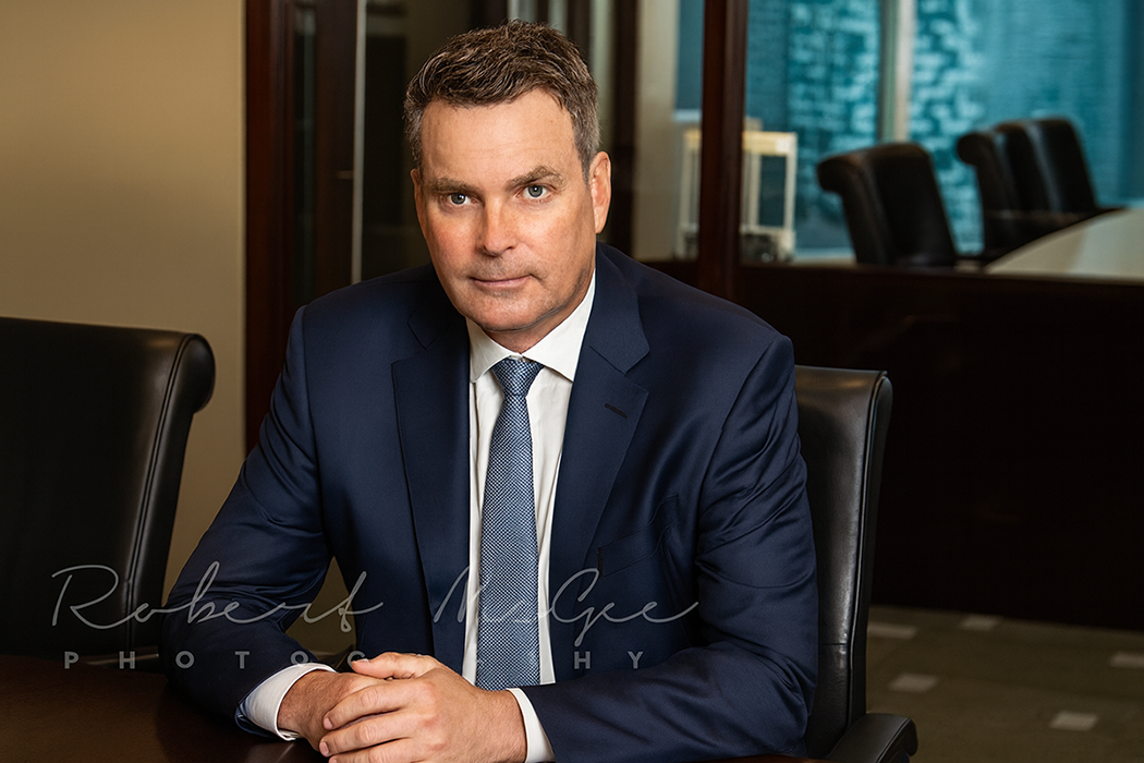 Warren from Rosseau Asset Management seated at conference table wearing business attire for professional headshot 019A2100