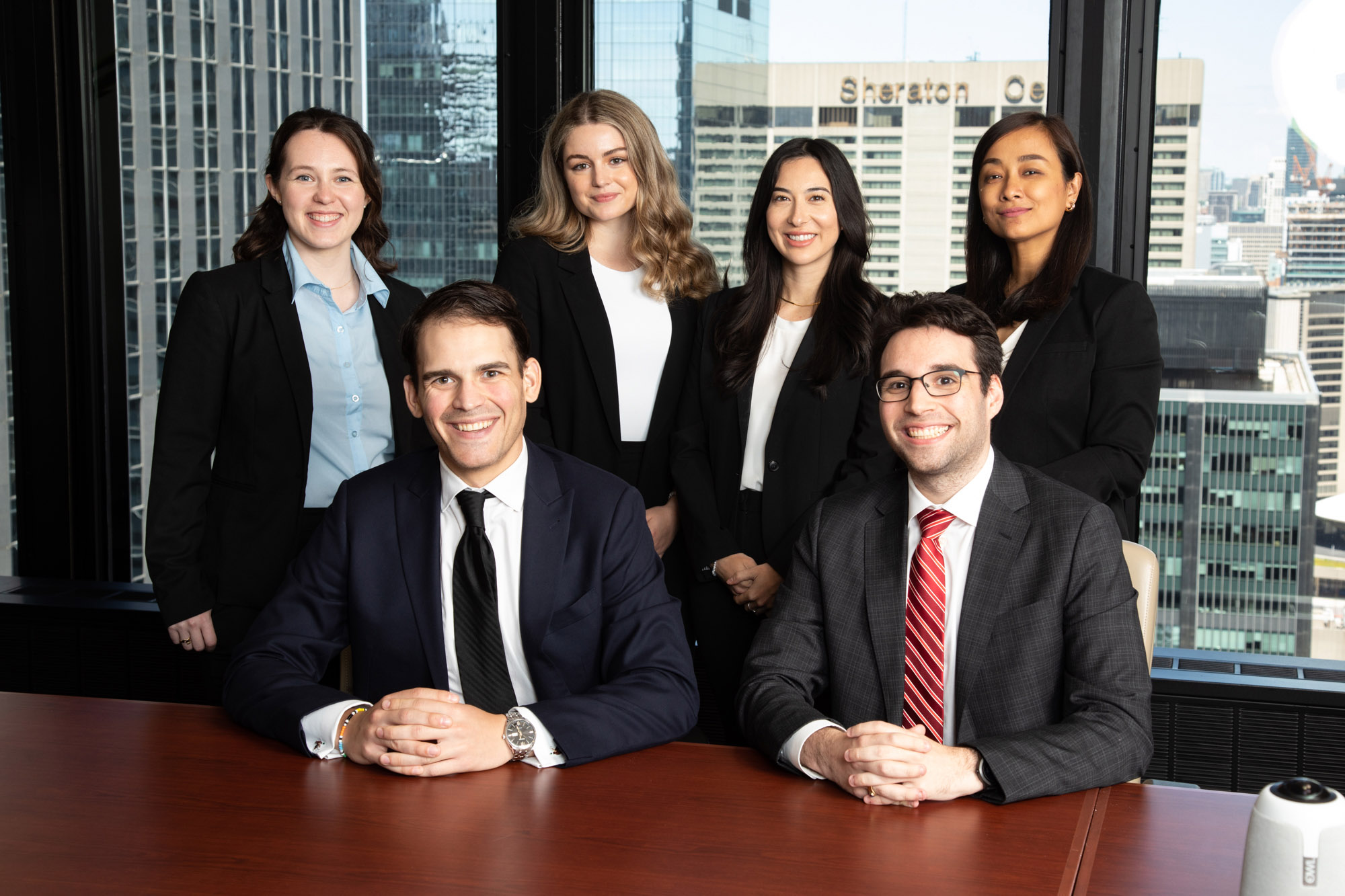 Corporate team photo in office boardroom with downtown Toronto skyline view, Robert McGee Photography