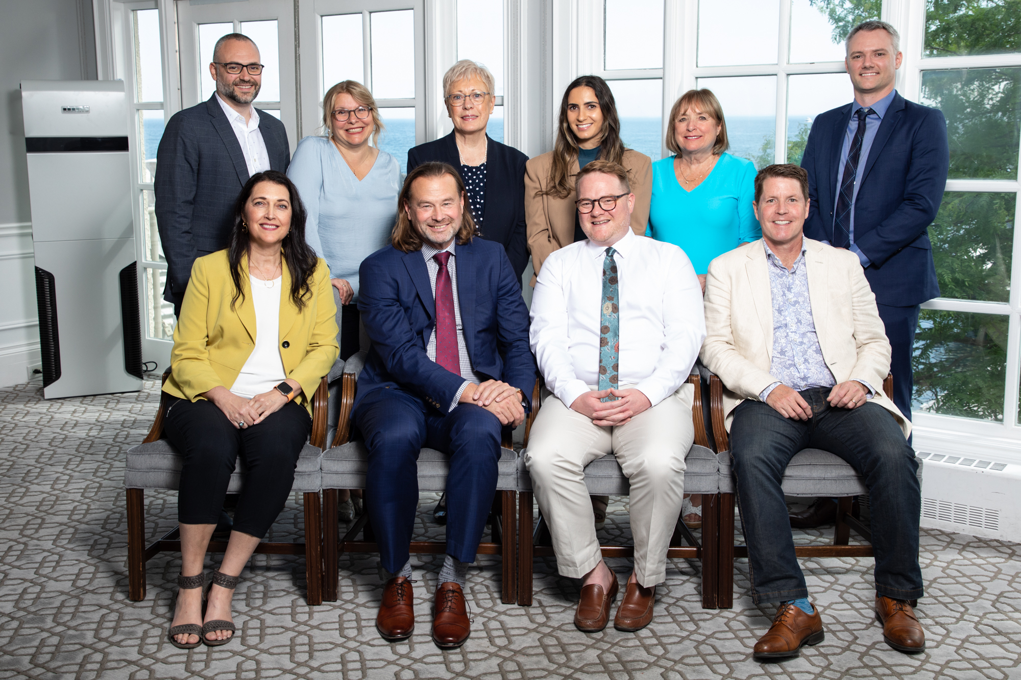 Executive corporate team portrait taken on location in bright venue with window view